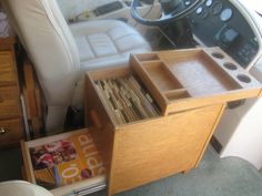 the inside of a boat with magazines and other items in it's storage compartment