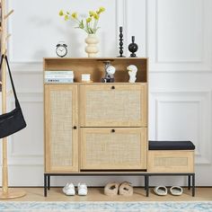 a wooden cabinet sitting next to a shelf with shoes and vases on top of it