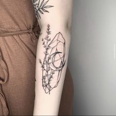 a woman's arm with a tattoo on it and a flower in the center