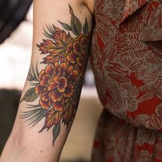 a woman with a flower tattoo on her arm