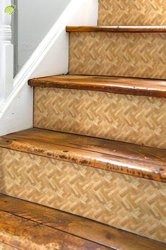 the stairs are made of wood and have woven treads on each side, along with a handrail