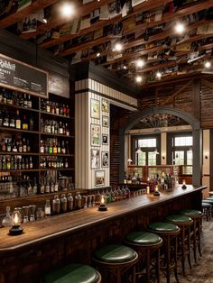 a bar with lots of stools and bottles on the shelves in front of it