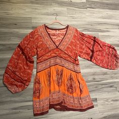 Free People Dress Never Worn Casual Red Long Sleeve Tunic, Red Short Sleeve Tunic For Spring, Bohemian Red V-neck Mini Dress, Red Bohemian V-neck Mini Dress, Long Sleeve Orange Tunic For Summer, Red Long Sleeve Beach Tunic, Casual Red Tunic For Vacation, Orange Long Sleeve Boho Dress, Casual Red Rayon Dress