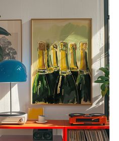 a painting of champagne bottles on a wall above a table with record player and stereo