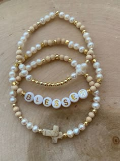 Beaded Bracelets Ideas Aesthetic, Christian Heishi Bracelets, Godly Bracelets, Personalized Beaded Bracelets, Neutral Bracelet Ideas, Neutral Beaded Bracelets, Bracelet Pictures Ideas, Name Bracelet Beads