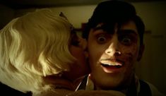 a man and woman kissing in the dark with makeup on their faces, as if they were zombies