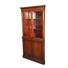 an old wooden bookcase with glass doors on the front and bottom shelves, against a white background