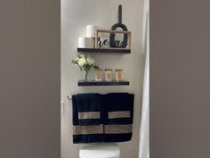 a white toilet sitting in a bathroom next to a wall mounted shelf filled with bottles