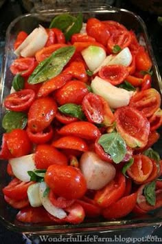 tomatoes, onions and other vegetables in a glass dish