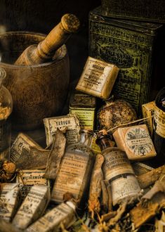 an assortment of old bottles and jars on the ground next to each other with writing on them