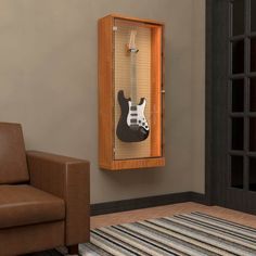 a guitar case hanging on the wall next to a chair