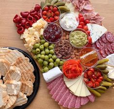 a platter filled with cheese, crackers, olives, and other foods