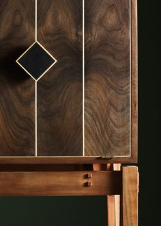 a close up of a wooden table with a clock on it's back side