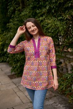 🌷 ANANDA Add a splash of colour to your wardrobe with our Ananda Tunic in vibrating floral prints. Ananda was created for a comfortable loose fit, and decorated with floral hand block prints. Sizings: Size S:   Shoulders 38cm - 14.9" Bust  96cm - 37.7" Length approx. 71cm - 29.5" Size M:   Shoulders 40cm - 15.7" Bust  100cm - 40" Length approx. 75cm - 29.5" Size L:   Shoulders 44cm - 17.3" Bust  106cm - 42" Length approx. 75cm - 29.5" Materials: Fabric: 100% Hand Block Printed Cotton  Care Inst Summer Split Neck Pink Blouse, Hippie Pink V-neck Tops, Pink Bohemian Relaxed Fit Blouse, Casual Multicolor Block Print Blouse, Purple Cotton Summer Blouse, Casual Pink Tunic Blouse, Summer Purple Cotton Blouse, Pink Bohemian Cotton Top, Beach Purple Printed Blouse