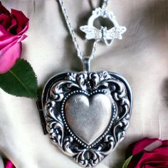 "Heart music box pendant. This heart shaped music box is inspired by the gorgeous music box pendants of era's gone by.  A heart shaped locket has been adorned with a silver ox stamping of a lacey edged floral heart with a solid heart center. The lacey edged floral heart has been covered in a clear resin to give a glass like finish and preserve the beauty of this musical pendant.  The locket opens and closes by pushing the little button on the side and reveals a tiny working music box that plays an 18 note musical tune.  Choose the music box tune you would like at checkout.To listen to the music box tunes, get more information on our music boxes and see our limited addition tune list, go to http://bit.ly/1VJ9Amj The inside front cover of the locket has a lacey floral finish.  You can leave Vintage Heart Locket Necklace For Mother's Day, Vintage Heart Necklace For Mother's Day, Vintage Engraved Heart Necklace For Mother's Day, Vintage Style Engraved Heart Necklace For Mother's Day, Vintage Locket Necklace With Heart Charm For Gifting, Vintage Heart Charm Locket Necklace As A Gift, Vintage Heart Necklace For Valentine's Day Keepsake, Vintage Silver Locket Necklace For Mother's Day, Vintage Heart Locket Necklace Nickel Free