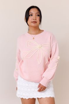 Our Tangled Up Sweater is a cozy and blush pink sweater. It features a textured bow overlay design throughout the body and sleeves. It has a crew neckline and ribbed trims that provide a perfect fit. It has a super soft fabric.Model wears a size smallModel is 5'1"39% Acrylic, 31% Polyester, 30% PolyamideSize small measurements:Bust: 22"Waist: 34" Pink Knit Top For Spring, Feminine Crew Neck Sweater For Winter, Feminine Spring Crew Neck Sweater, Feminine Crew Neck Winter Sweater, Spring Feminine Crew Neck Sweater, Pink Cable Knit Tops For Spring, Feminine Soft Knit Sweater For Spring, Pink Feminine Sweater For Loungewear, Feminine Crew Neck Sweater For Fall