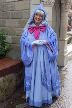 an older woman dressed in a blue costume