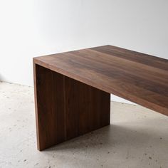 a wooden table sitting on top of a white floor