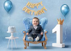 a baby sitting in a blue chair with balloons