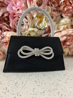 Crystal embezzled handle with bow accent front, top handle style. Luxury Party Shoulder Bag With Bow, Elegant Bags With Bow For Everyday Use, Luxury Shoulder Bag With Bow For Party, Elegant Formal Shoulder Bag With Bow, Formal Shoulder Bag With Detachable Bow, Chic Formal Shoulder Bag With Bow, Party Clutch Bags With Bow Detail, Party Clutch Bags With Bow, Elegant Clutch Bag With Bow