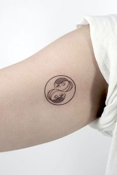 a woman's arm with a tattoo design on the left side of her arm