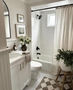 a bathroom with a checkered floor and white walls