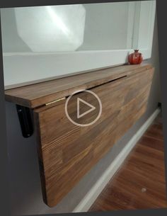 a close up of a wooden shelf with an apple on it