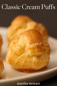 several puffs on a white plate with the words classic cream puffs