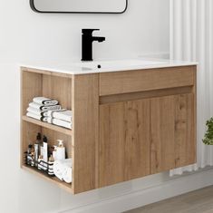 a bathroom with a sink, mirror and towel rack on the wall next to it