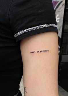 a person with a tattoo on their arm that says, made of memories written in cursive writing