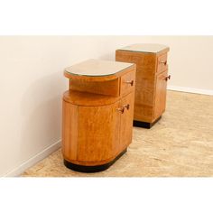 two wooden side tables sitting next to each other