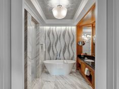 an elegant bathroom with marble walls and flooring, along with a freestanding bathtub