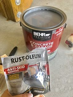 someone is holding up a packet of rustoleum in front of a paint can