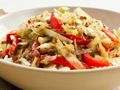 a white bowl filled with cabbage and red peppers