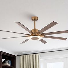 a ceiling fan with wooden blades in a living room