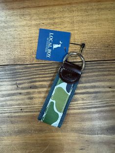 Elevate your everyday essentials with the Local Boy Logo Keychain, featuring a striking Forest Camo design. This durable and stylish keychain showcases the iconic Local Boy logo prominently, making it a perfect accessory for any outdoor enthusiast or fan of the brand. Crafted for both function and flair, it’s a practical way to keep your keys secure while adding a touch of rugged style to your gear. Whether you’re hitting the trails or just heading out for the day, this keychain is a great way t Rectangular Keychain With Key Leash For Daily Use, Camo Designs, Youth Shoes, Toddler Socks, 2024 Christmas, Rugged Style, Outdoor Enthusiast, Toddler Shoes, Dog Accessories