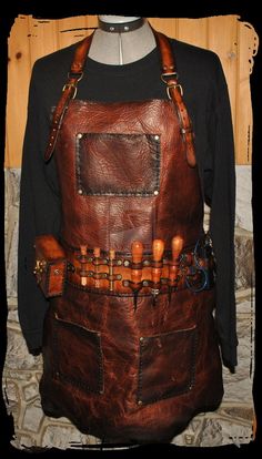 an apron made out of leather with wooden buttons on the front and straps around it