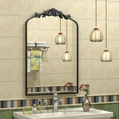 a bathroom with a sink, mirror and hanging lights