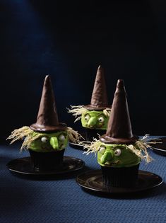 three green cupcakes with witches hats on them