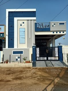 a blue and white house with stairs leading up to it