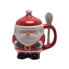 a santa clause mug with a spoon in it's mouth and a red handle