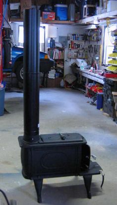 a black stove sitting inside of a garage