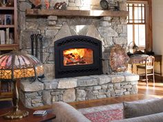 a stone fireplace with a fire in it