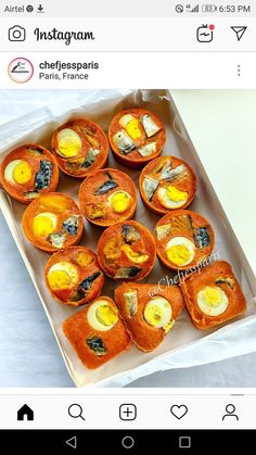 an open box filled with baked food on top of a table