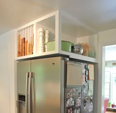 a stainless steel refrigerator with magnets on it