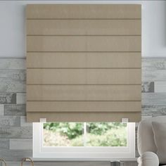 a bedroom with a bed and window covered in roman blind shades on the windowsill