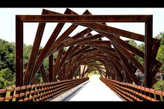 an image of a wooden bridge going over water