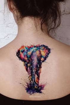 an elephant tattoo on the back of a woman's neck