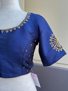 Blue Color Raw Silk Blouse with beautiful Handwork Work done with beads. Item : Readymade BlouseColor : Blue Color Blouse Fabric : Raw Silk Lining : Yes, it is fully lined Padded or Non-Padded : PaddedClosure: Front Closure with hooks.Ready-to-Wear : YesDisclaimer - : -This is a Standard Size blouse. We do not guarantee perfect fit as every body and shape is different. Little or no alteration would be required to get the perfect fit. - Color variation is possible due to various reasons like phon Blouses For Sarees, Blouse Handwork, Green Color Saree, Magam Work Designs, Magam Work, Afrocentric Fashion, Padded Blouse, Color Blouse, Readymade Blouse