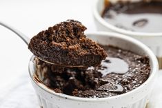 a spoon full of chocolate cake in a cup